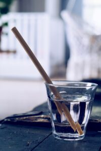 clear drinking glass with brown straw